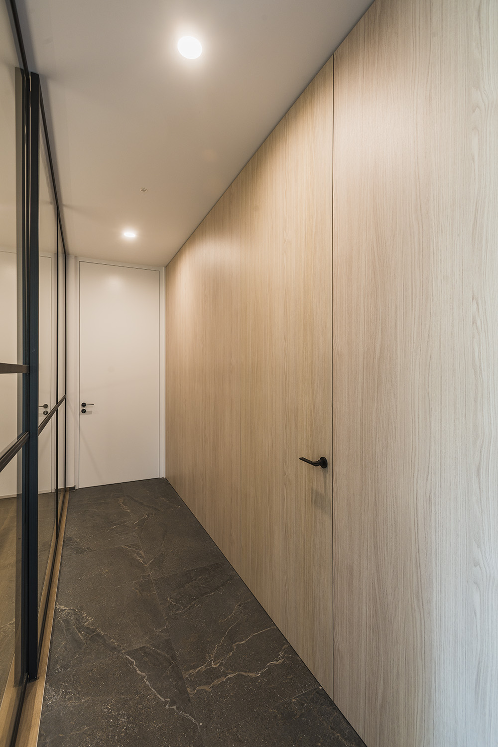 Integration of invisible hinges for wooden doors flush with the wall.